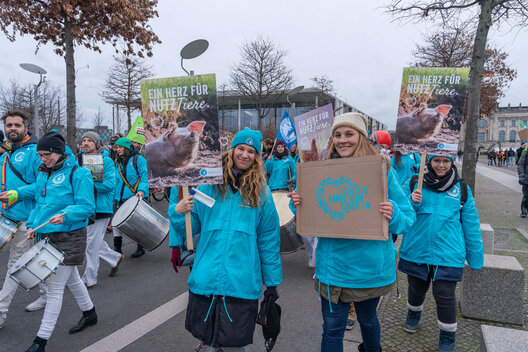 Employees of the German Animal Welfare Federation demonstrate at the Wir haben es satt demo and hold up protest signs