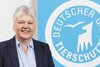 Portrait of Ellen Kloth from the co-opted presidium in front of the logo of the German Animal Welfare Federation